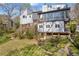 Beautiful backyard view showing multi-tiered decks, full sunroom, steps, and landscaping at 10845 Shallowford Rd, Roswell, GA 30075