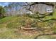 The lush backyard features a charming rock water feature, creating a tranquil outdoor space at 10845 Shallowford Rd, Roswell, GA 30075