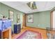 Finished basement featuring hardwood floors, fish tank, and open doorways at 10845 Shallowford Rd, Roswell, GA 30075