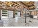 Unfinished basement area with large windows, offering potential for customization at 10845 Shallowford Rd, Roswell, GA 30075