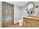 Bathroom featuring a custom vanity, wood floors, and unique lighting fixtures at 10845 Shallowford Rd, Roswell, GA 30075