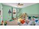 Charming bedroom with pastel green walls and plenty of soft toys, perfect for a play and relaxation at 10845 Shallowford Rd, Roswell, GA 30075
