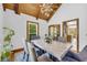 Dining room featuring wood floors, natural lighting, modern chandelier and seating for six at 10845 Shallowford Rd, Roswell, GA 30075