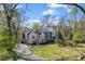 Charming home with mature trees, a winding driveway, and professionally landscaped front yard at 10845 Shallowford Rd, Roswell, GA 30075