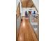 Hardwood hallway with wooden railing leading to an upstairs office space, perfect for working from home at 10845 Shallowford Rd, Roswell, GA 30075