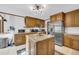 Charming kitchen with oak cabinets, stainless steel appliances, granite counters, and a kitchen island at 10845 Shallowford Rd, Roswell, GA 30075