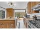 Charming kitchen with oak cabinets, stainless steel appliances, granite counters, and a kitchen island at 10845 Shallowford Rd, Roswell, GA 30075