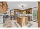 Charming kitchen with oak cabinets, stainless steel appliances, granite counters, and a kitchen island at 10845 Shallowford Rd, Roswell, GA 30075
