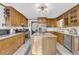 Charming kitchen with oak cabinets, stainless steel appliances, granite counters, and a kitchen island at 10845 Shallowford Rd, Roswell, GA 30075