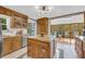 Charming kitchen with oak cabinets, stainless steel appliances, granite counters, and a kitchen island at 10845 Shallowford Rd, Roswell, GA 30075