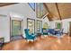 Bright living room with hardwood floors, vaulted ceiling, and oversized windows at 10845 Shallowford Rd, Roswell, GA 30075