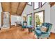 Bright living room with a high wood ceiling, plentiful natural light and traditional furnishings at 10845 Shallowford Rd, Roswell, GA 30075