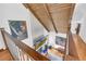 View from a staircase down to the living room with a fireplace and high wood ceilings at 10845 Shallowford Rd, Roswell, GA 30075