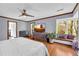 Bright bedroom with hardwood floors, large windows, and a cozy window seat to enjoy the outdoors at 10845 Shallowford Rd, Roswell, GA 30075