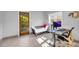 Bright office space with tile flooring, a door leading to the outside, and a modern desk setup at 10845 Shallowford Rd, Roswell, GA 30075