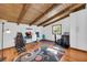 Home office with a wooden ceiling and floors, gaming chair, and a large window at 10845 Shallowford Rd, Roswell, GA 30075