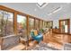 Bright sunroom with skylights, walls of windows, hardwood flooring, and comfortable furniture at 10845 Shallowford Rd, Roswell, GA 30075