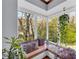 Cozy sun room nook with a bench seat, pillows, and views of the backyard at 10845 Shallowford Rd, Roswell, GA 30075