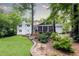 Expansive backyard view showcases a screened-in porch and expertly manicured landscaping, perfect for relaxing outdoors at 1329 W Nancy Creek Ne Dr, Brookhaven, GA 30319