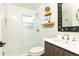 Updated bathroom featuring a glass-enclosed shower, modern vanity, and floating shelves at 1329 W Nancy Creek Ne Dr, Brookhaven, GA 30319
