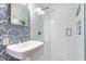 Stylish bathroom featuring tiled shower with glass door, modern sink, and elegant blue-patterned wallpaper at 1329 W Nancy Creek Ne Dr, Brookhaven, GA 30319