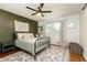 Cozy bedroom with an accent wall, ceiling fan, and a large window providing great natural light at 1329 W Nancy Creek Ne Dr, Brookhaven, GA 30319
