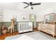 Spacious bedroom featuring neutral walls, wood floors, a white crib and dresser set with ample storage at 1329 W Nancy Creek Ne Dr, Brookhaven, GA 30319