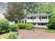 Charming two-story home featuring landscaped front yard, complemented by trees for added shade at 1329 W Nancy Creek Ne Dr, Brookhaven, GA 30319