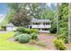 Charming two-story home featuring landscaped front yard, complemented by trees for added shade at 1329 W Nancy Creek Ne Dr, Brookhaven, GA 30319