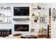 Close-up of a modern fireplace framed by white built-ins with shelving for decor at 1329 W Nancy Creek Ne Dr, Brookhaven, GA 30319