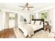 Bright main bedroom with hardwood floors, neutral decor, and three windows providing ample natural light at 1329 W Nancy Creek Ne Dr, Brookhaven, GA 30319