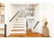 Inviting staircase with beautiful wood floors, white risers, and decorative basket at 1329 W Nancy Creek Ne Dr, Brookhaven, GA 30319