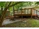 Backyard with deck, fire pit area, and a lush lawn, ideal for outdoor entertaining and relaxation at 2041 Trailwood Rd, Decatur, GA 30032