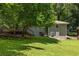 Expansive backyard with lush green lawn, mature trees, and a charming wooden deck for outdoor enjoyment at 2041 Trailwood Rd, Decatur, GA 30032
