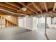 Unfinished basement with exposed wood beams, laundry area, and painted concrete floor at 2041 Trailwood Rd, Decatur, GA 30032