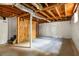 Spacious unfinished basement with visible beams, concrete floor, and white-wrapped walls at 2041 Trailwood Rd, Decatur, GA 30032