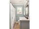 Cozy bathroom with patterned shower curtain, vanity with marble countertop, and framed mirror at 2041 Trailwood Rd, Decatur, GA 30032