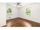 Empty bedroom with wood floor features picture window and modern ceiling fan at 2041 Trailwood Rd, Decatur, GA 30032