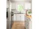 Well-lit kitchen features white cabinetry, stainless steel appliances, and a functional island at 2041 Trailwood Rd, Decatur, GA 30032