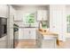 Modern kitchen with white cabinets, stainless steel appliances and center island at 2041 Trailwood Rd, Decatur, GA 30032