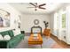 Bright living room featuring a green sofa, wooden furniture, and a striped rug at 2041 Trailwood Rd, Decatur, GA 30032
