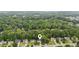 Aerial view showcasing a home nestled among mature trees in a quiet residential neighborhood at 5519 Princeton Oaks Ln, Sugar Hill, GA 30518