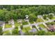 Aerial view highlighting a home in a tranquil neighborhood surrounded by lush greenery and mature trees at 5519 Princeton Oaks Ln, Sugar Hill, GA 30518