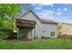 Image shows a beautiful backyard with a covered deck, a well-maintained lawn, and an air conditioning unit at 5519 Princeton Oaks Ln, Sugar Hill, GA 30518