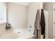Bathroom with a soaking tub and decorative features at 5519 Princeton Oaks Ln, Sugar Hill, GA 30518