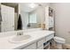 Bathroom featuring a white countertop, sink, toilet and storage cabinet at 5519 Princeton Oaks Ln, Sugar Hill, GA 30518