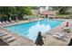 A community pool with plenty of lounge chairs, tables, and umbrellas for residents to enjoy at 5519 Princeton Oaks Ln, Sugar Hill, GA 30518