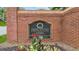 A brick sign for Princeton Oaks, a Sugar Hill community, with colorful flowers in the landscape at 5519 Princeton Oaks Ln, Sugar Hill, GA 30518