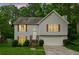 Charming two-story home featuring a well-manicured lawn, attached garage, and inviting entrance at 5519 Princeton Oaks Ln, Sugar Hill, GA 30518