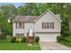 Charming two-story home featuring a well-manicured lawn, attached garage, and inviting entrance at 5519 Princeton Oaks Ln, Sugar Hill, GA 30518